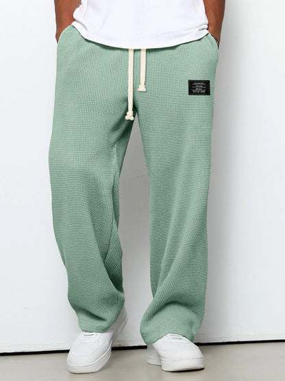 Men's trousers featuring an adjustable waistband and relaxed fit, made from breathable lightweight fabric, perfect for casual and smart wear. 5