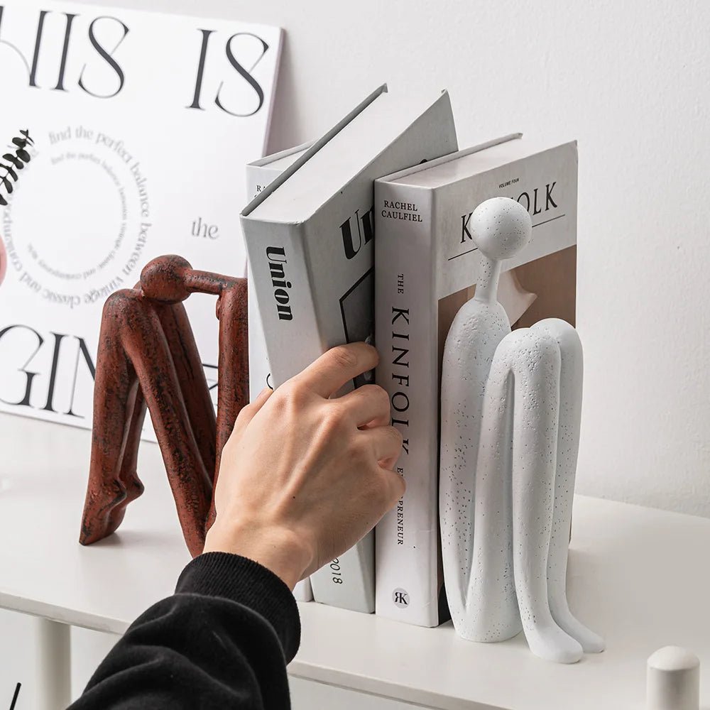 Minimalist bookshelf for small spaces featuring a durable steel and plastic design in brown and white colors, ideal for organizing books and decorative items. 2