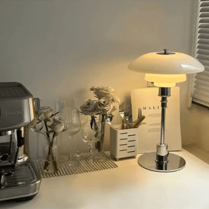 Minimalist table lamp featuring a warm LED light and elegant glass shade, ideal for bedside or desk use, with a sleek modern metal base. 1