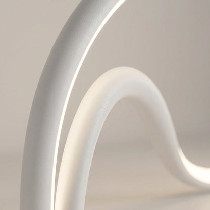 Modern table lamp featuring an integrated LED light with a sleek metal and acrylic finish, designed for compact use on bedside tables or desks. 2