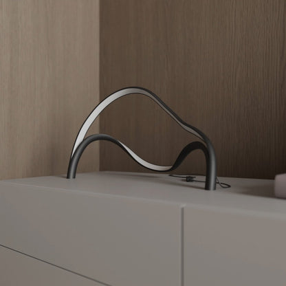 Modern table lamp featuring an integrated LED light with a sleek metal and acrylic finish, designed for compact use on bedside tables or desks. 3