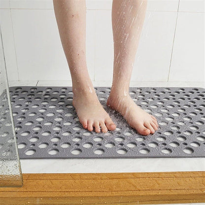 Non-slip shower mat featuring strong suction cups for stability, quick drainage holes for efficient water flow, and mold-resistant material for a hygienic bathroom experience. 2