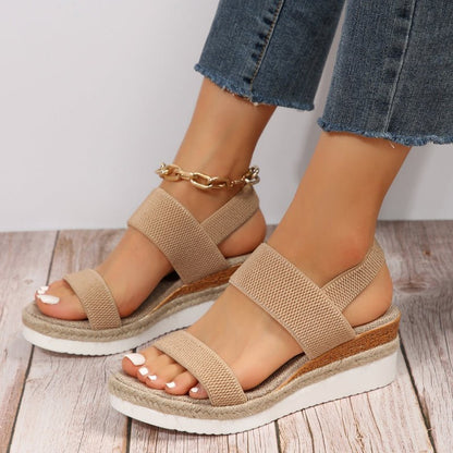 Lightweight orthopedic platform sandals featuring elastic straps and a sporty sole, designed for comfort and support, made from vegan materials. 1