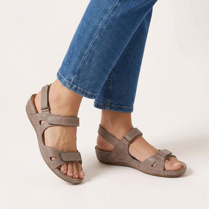Orthopedic sandals for women featuring an adjustable strap and open toe design, designed for comfort with arch support for all-day wear. 2