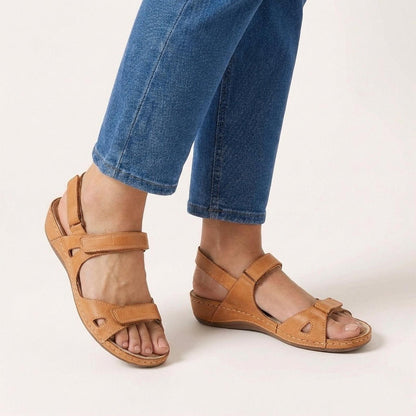 Orthopedic sandals for women featuring an adjustable strap and open toe design, designed for comfort with arch support for all-day wear. 1