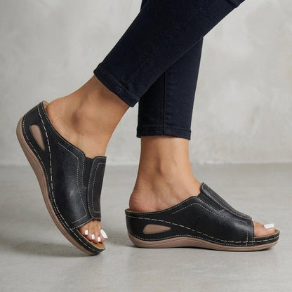 Orthopedic wedge sandals for women featuring arch support, open-toe design, and slip-on leather comfort, perfect for all-day wear. 2
