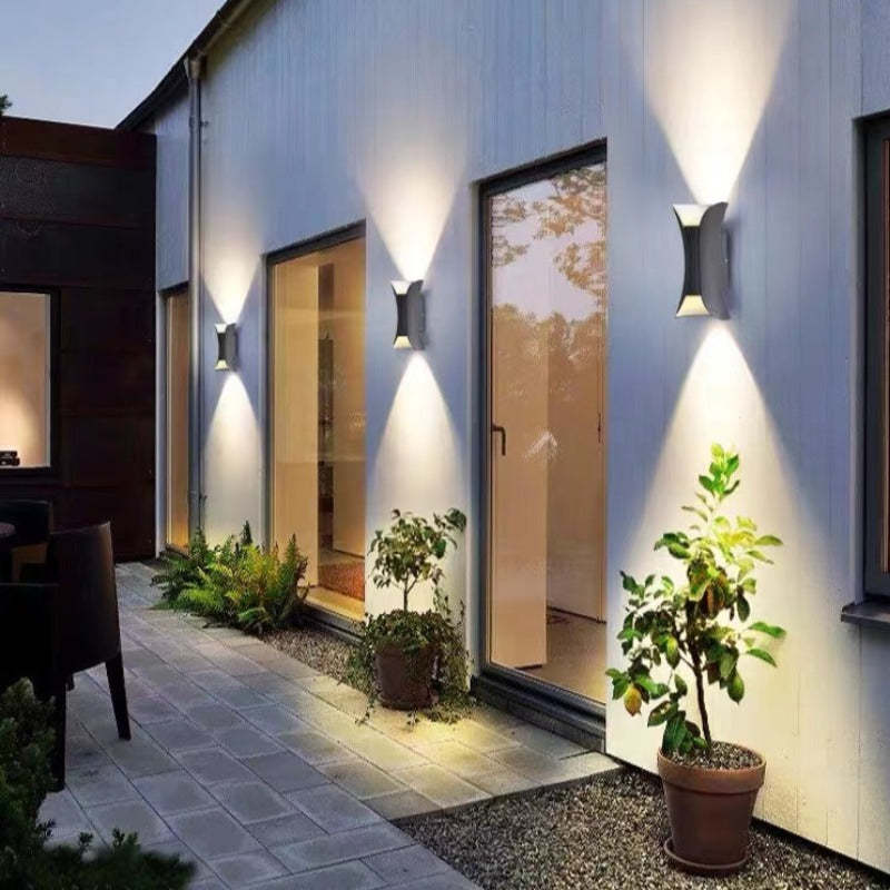 Outdoor wall lamp featuring a sleek curved design, dual LED emission, and a weather-resistant IP65 rating, ideal for enhancing exterior lighting in gardens and patios 3