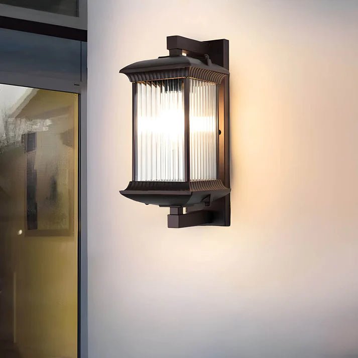 Outdoor wall lamp featuring elegant curved glass panels and a weather-resistant coffee brown metal finish, perfect for illuminating patios and entrances. 2