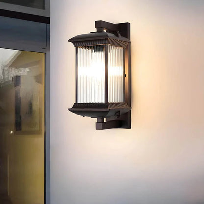 Outdoor wall lamp featuring elegant curved glass panels and a weather-resistant coffee brown metal finish, perfect for illuminating patios and entrances. 2