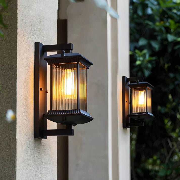 Outdoor wall lamp featuring elegant curved glass panels and a weather-resistant coffee brown metal finish, perfect for illuminating patios and entrances. 1