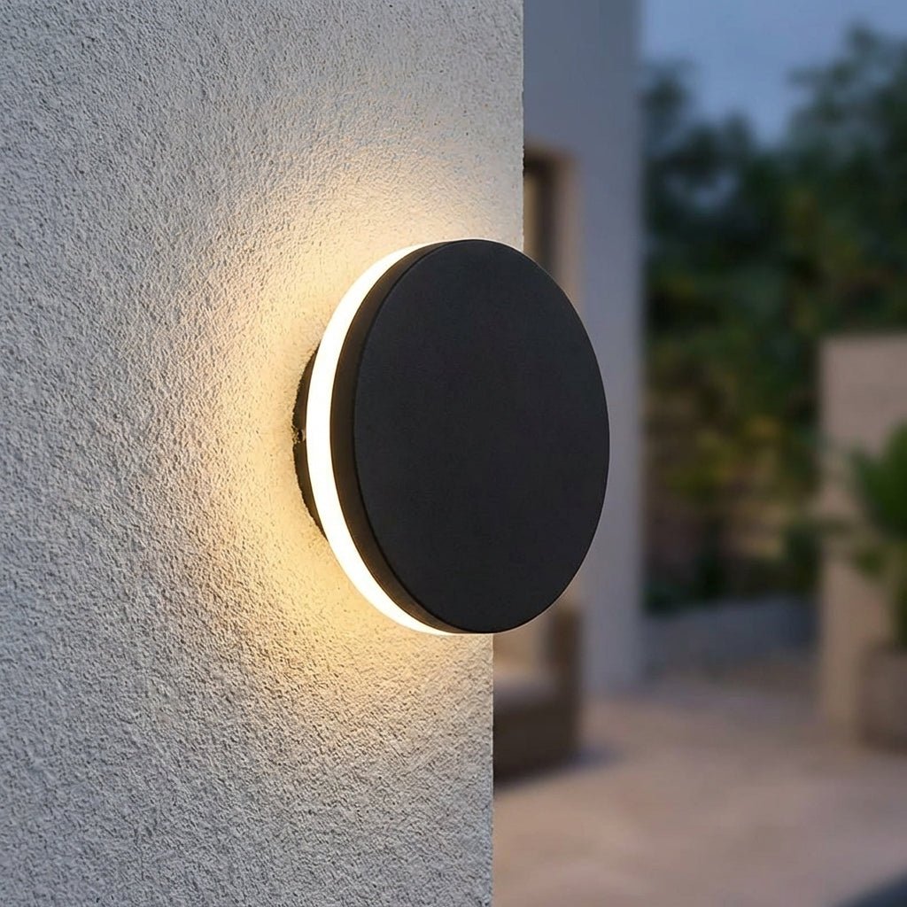 Modern outdoor wall lamp featuring up and down lighting, crafted from weatherproof metal for durable exterior use. 1