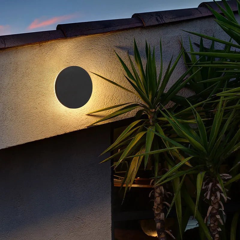 Modern outdoor wall lamp featuring up and down lighting, crafted from weatherproof metal for durable exterior use. 4