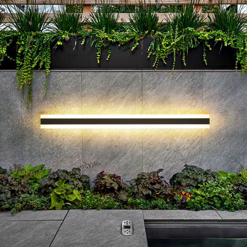 Outdoor wall lamp featuring a minimalist iron design and warm white LED glow, ideal for enhancing exterior lighting in gardens, patios, and entryways. 4