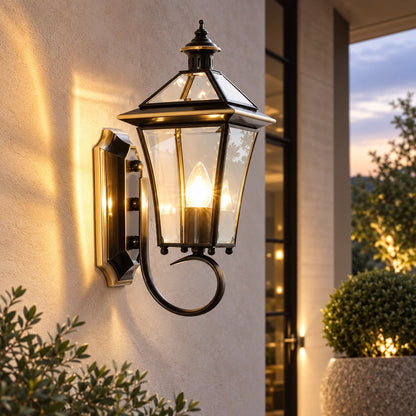 Outdoor wall lantern featuring a weatherproof brass frame and transparent glass shade, designed in a retro style, compatible with E26 LED bulbs. 2
