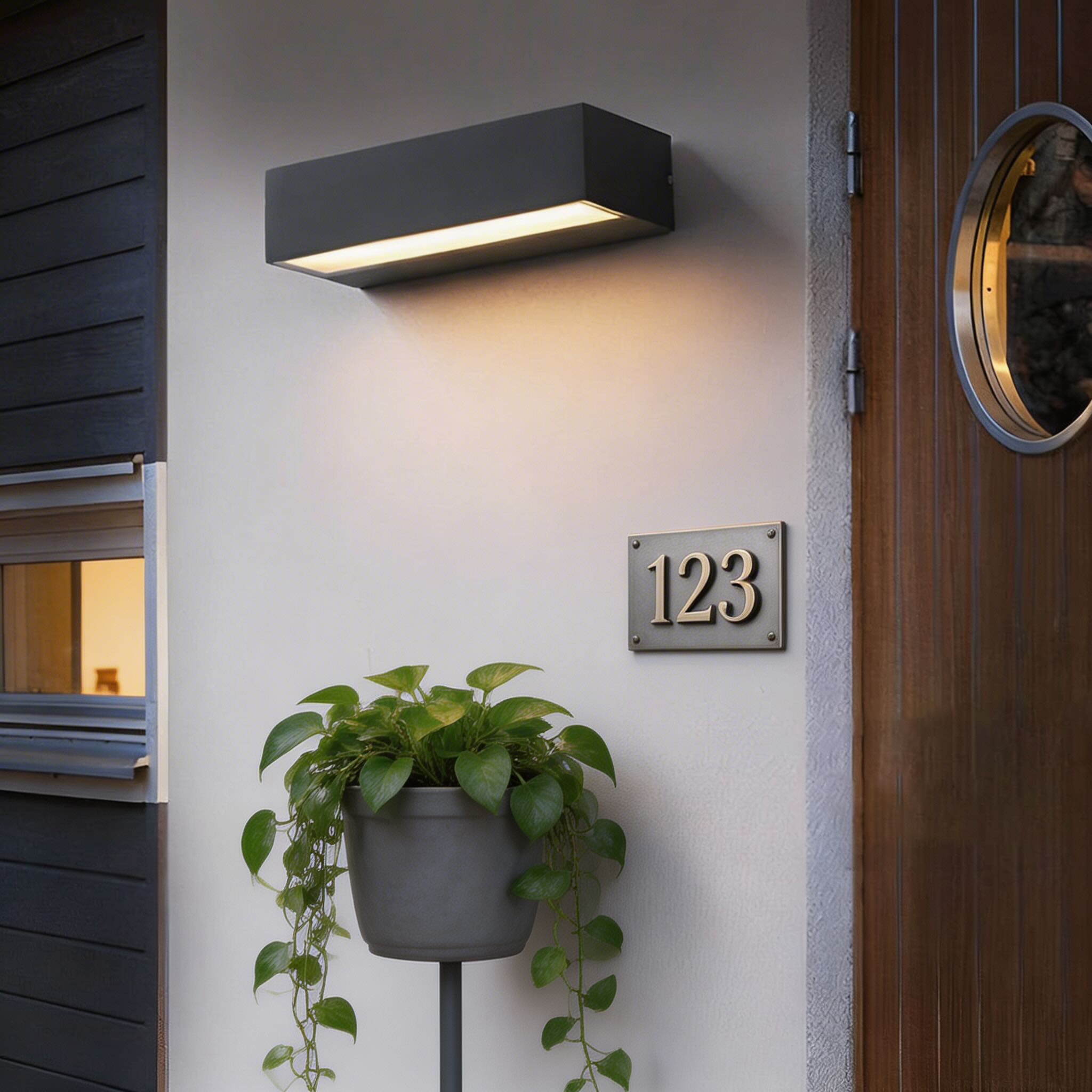 Modern black outdoor wall light featuring adjustable LED color temperature, designed with a sleek linear style and rated IP65 for waterproof durability. 0