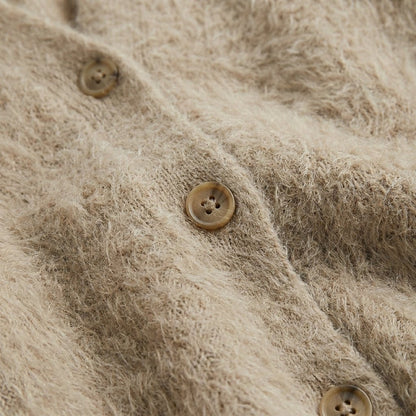 Oversized women's cardigan featuring a deep V-neck and relaxed fit, made from soft knit fabric, perfect for layering. 3
