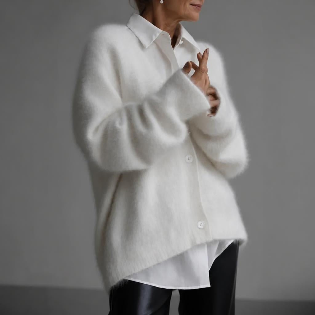 Oversized women's cardigan featuring a deep V-neck and relaxed fit, made from soft knit fabric, perfect for layering. 6