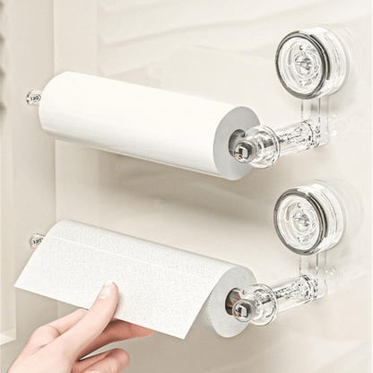Transparent plastic wall-mounted paper towel holder with a rotatable suction cup, ideal for kitchen organization and easy access to towels. 3