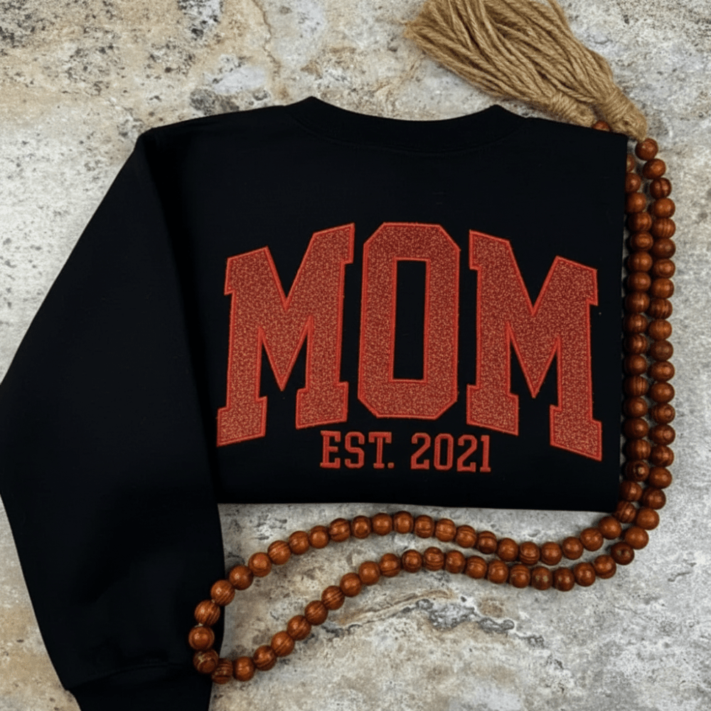 Personalized sweatshirt featuring custom name embroidery and subtle shimmer detail, designed for soft everyday wear. 4
