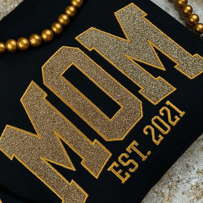 Personalized sweatshirt featuring custom name embroidery and subtle shimmer detail, designed for soft everyday wear. 3
