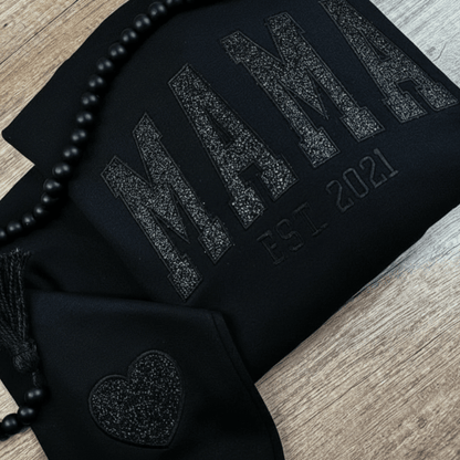 Personalized sweatshirt featuring custom name embroidery and subtle shimmer detail, designed for soft everyday wear. 1