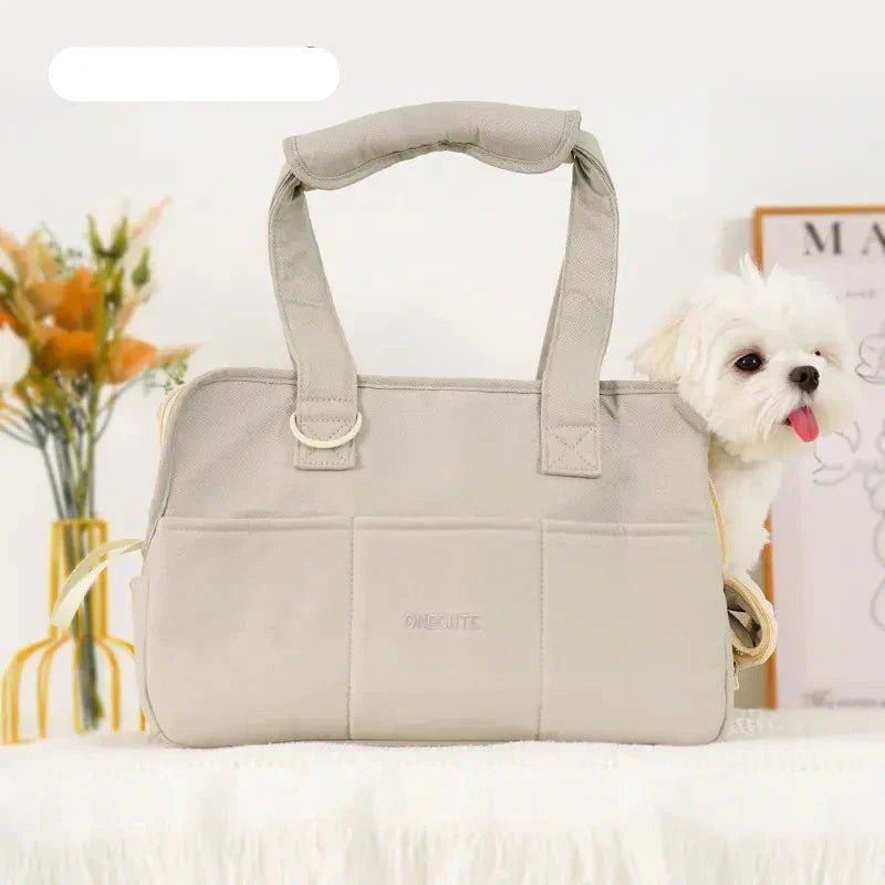 Lightweight pet carrier for cats and small dogs made from breathable cotton material, featuring a compact design ideal for travel. 2