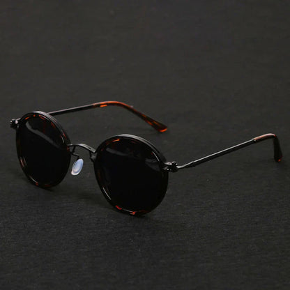 Polarized sunglasses featuring UV 400 protection and a shiny metal alloy frame, designed for stylish outdoor activities. 4