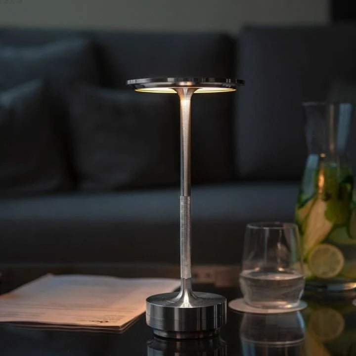 Portable cordless table lamp with adjustable brightness, featuring a sleek metallic finish, ideal for both indoor and outdoor use. 3