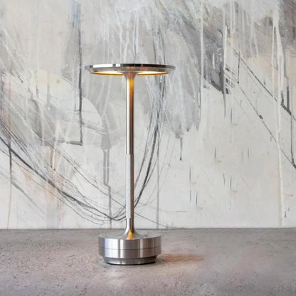 Portable cordless table lamp with adjustable brightness, featuring a sleek metallic finish, ideal for both indoor and outdoor use. 4