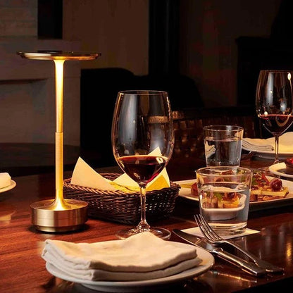 Portable cordless table lamp with adjustable brightness, featuring a sleek metallic finish, ideal for both indoor and outdoor use. 0