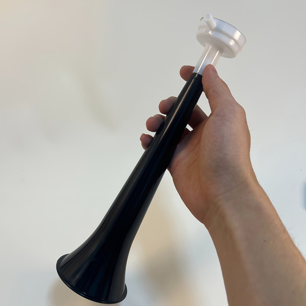Portable high decibel air horn in lightweight PVC design, perfect for events and safety use, showcased in a vibrant outdoor setting. 2