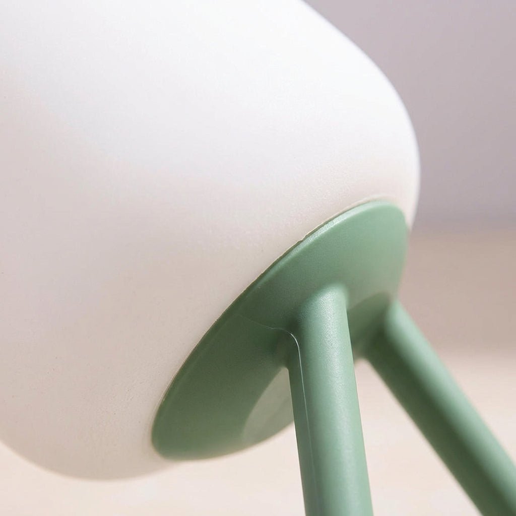 Portable LED night light featuring a soft ambient glow, available in green and blue, designed for battery-powered convenience and compact use. 3