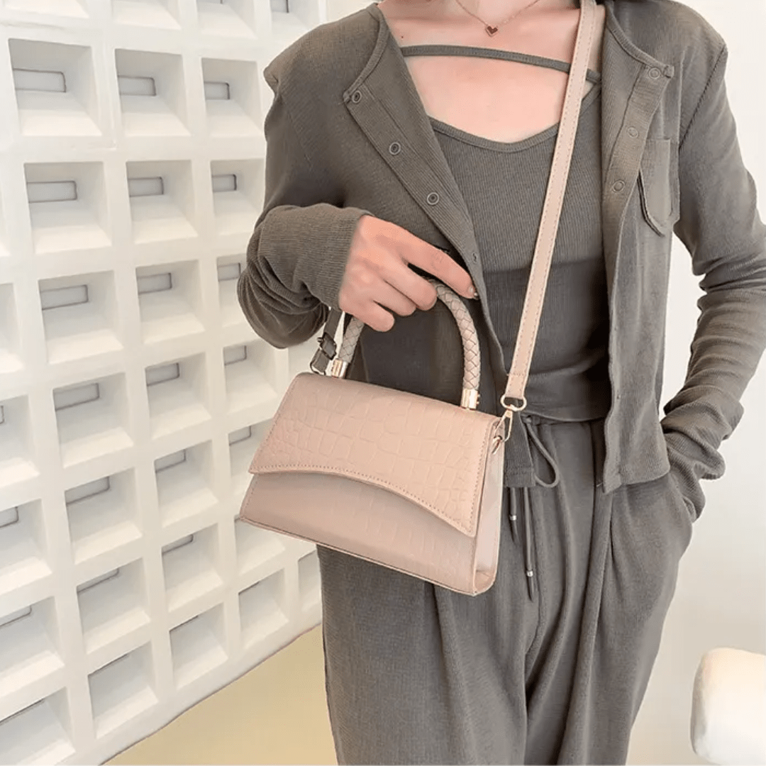 PU leather handbag featuring a stylish top handle and a detachable crossbody strap, perfect for everyday use with a classic design in a versatile color. 3