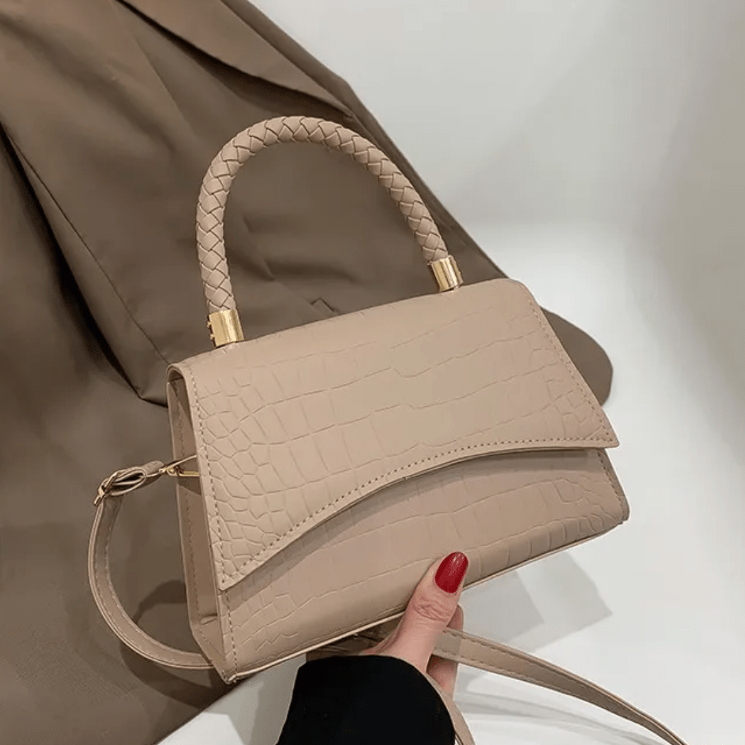 PU leather handbag featuring a stylish top handle and a detachable crossbody strap, perfect for everyday use with a classic design in a versatile color. 1