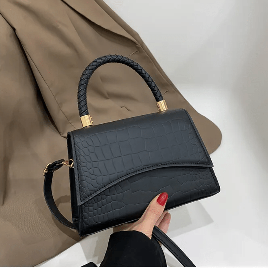 PU leather handbag featuring a stylish top handle and a detachable crossbody strap, perfect for everyday use with a classic design in a versatile color. 0