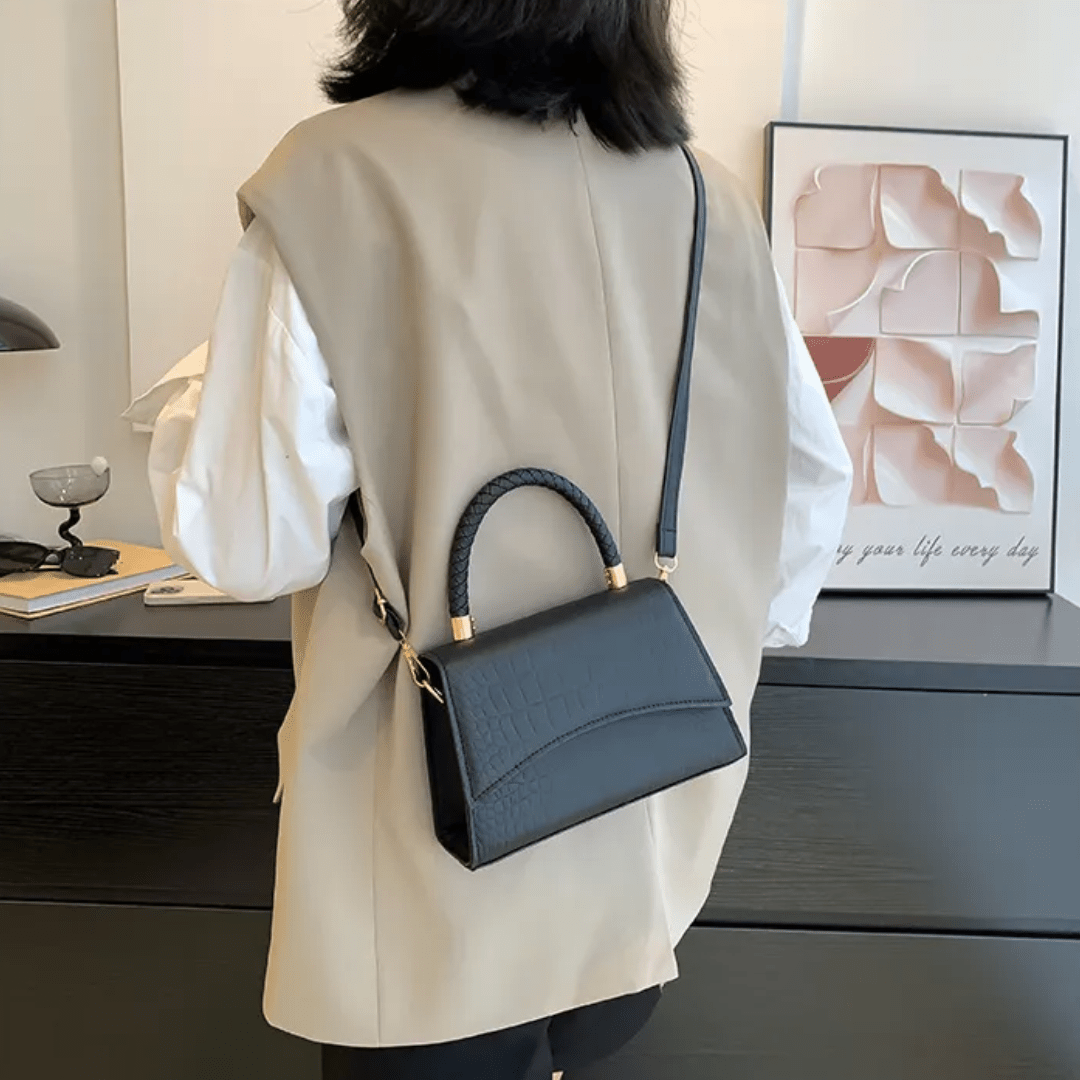 PU leather handbag featuring a stylish top handle and a detachable crossbody strap, perfect for everyday use with a classic design in a versatile color. 2