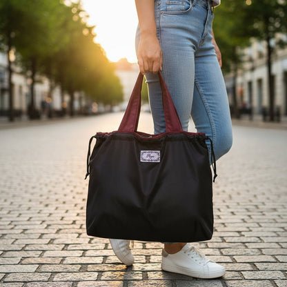Reusable tote bag with a rectangle design and wristlet strap, perfect for shopping and everyday use, featuring durable materials and stylish aesthetics. 16