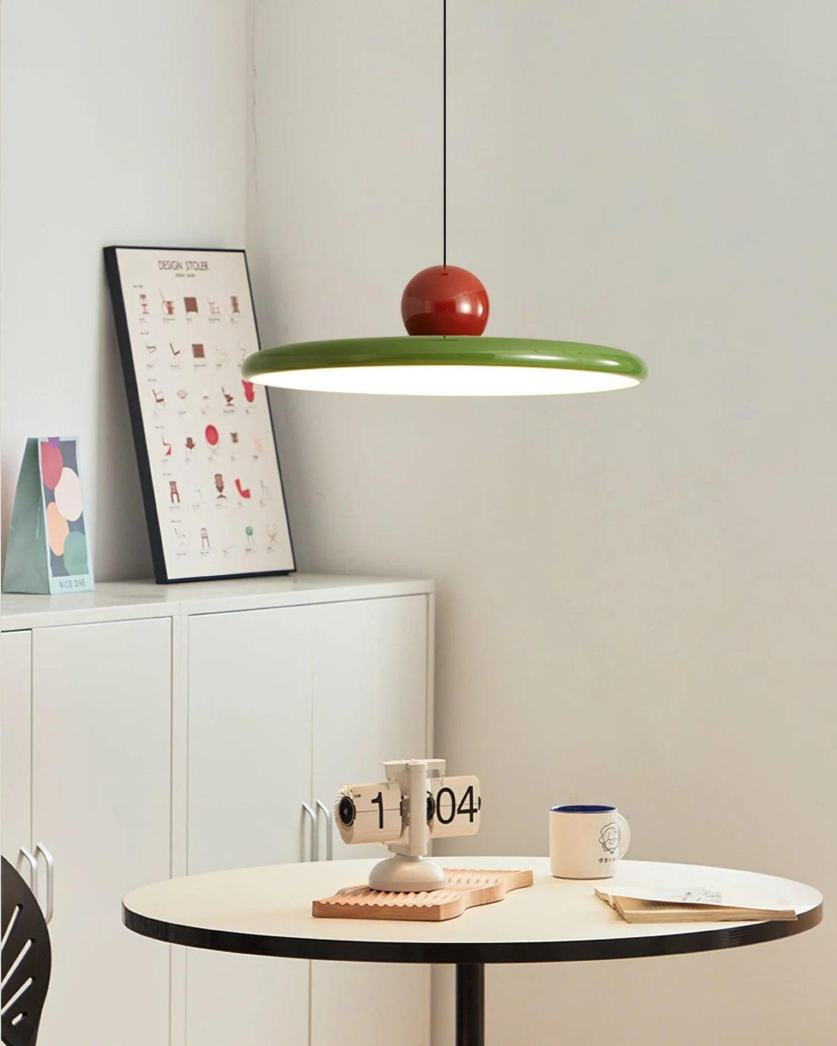 Round pendant light featuring an adjustable cable and integrated LED, showcasing a sleek modern metal and acrylic design, perfect for illuminating kitchen islands. 3