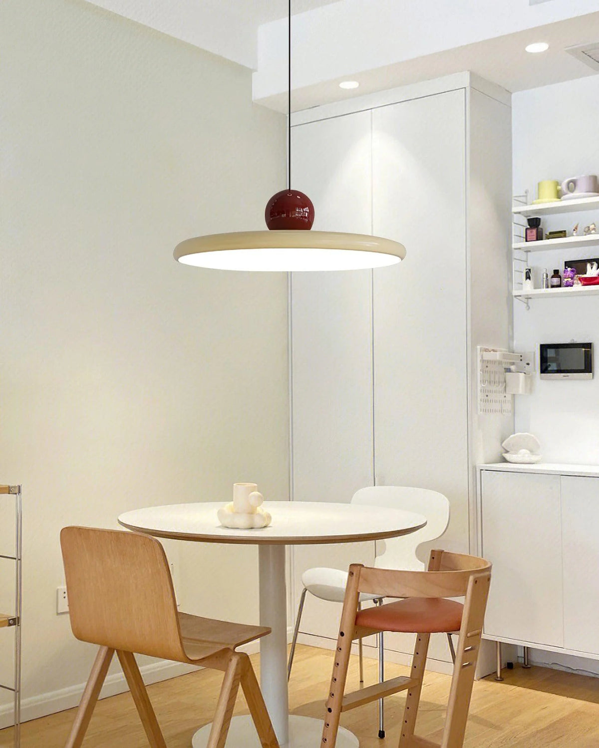 Round pendant light featuring an adjustable cable and integrated LED, showcasing a sleek modern metal and acrylic design, perfect for illuminating kitchen islands. 5