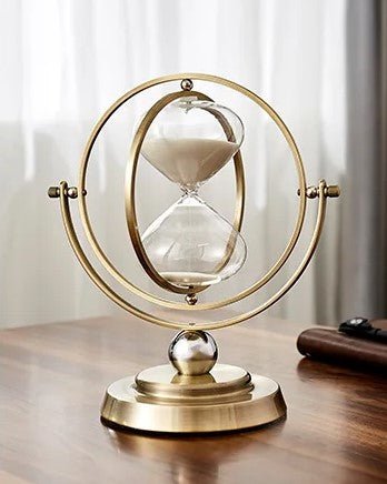 Scandinavian metal hourglass timer featuring an elegant brass and glass design, showcasing a stylish gold and white color scheme, perfect for home decor. 4