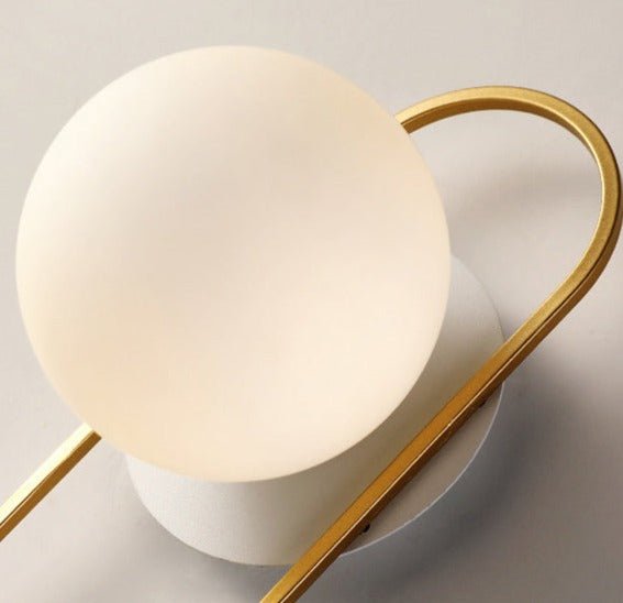 Scandinavian wall lamp featuring a modern minimalist design in gold and black with dimmable LED lighting for adjustable ambiance. 7