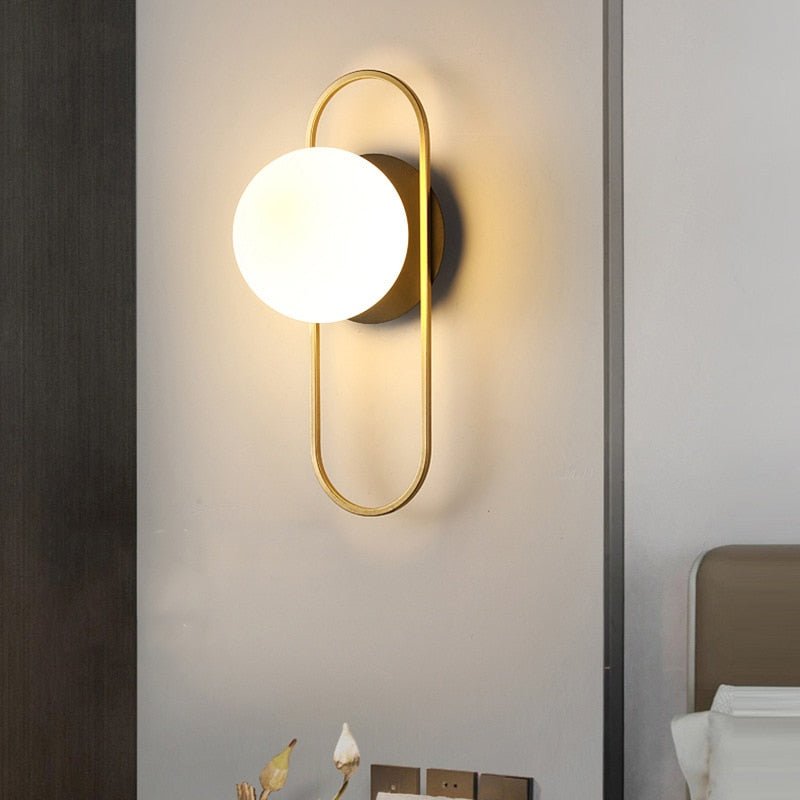 Scandinavian wall lamp featuring a modern minimalist design in gold and black with dimmable LED lighting for adjustable ambiance. 2