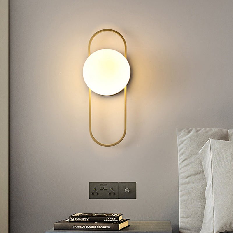 Scandinavian wall lamp featuring a modern minimalist design in gold and black with dimmable LED lighting for adjustable ambiance. 3