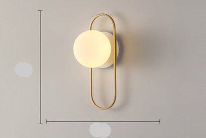 Scandinavian wall lamp featuring a modern minimalist design in gold and black with dimmable LED lighting for adjustable ambiance. 14