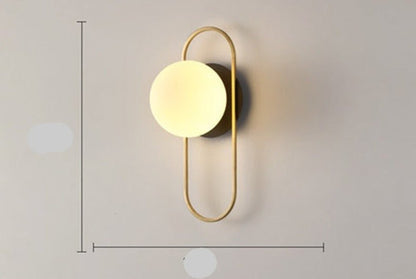 Scandinavian wall lamp featuring a modern minimalist design in gold and black with dimmable LED lighting for adjustable ambiance. 11