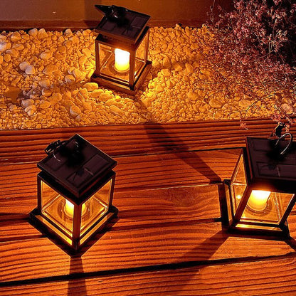 Solar hanging lantern featuring a realistic LED candle effect, perfect for adding a classic touch to outdoor spaces while providing eco-friendly illumination. 3