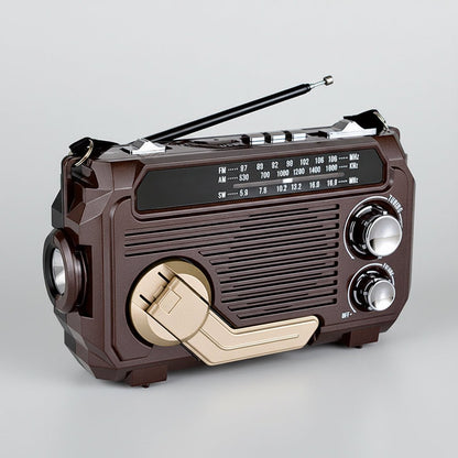 Solar-powered emergency radio with hand crank and Bluetooth, featuring a compact design and built-in flashlight for multi-function use during emergencies and outdoor activities. 3