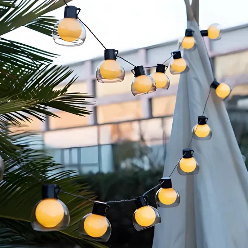 Solar string lights featuring warm white twinkle bulbs, perfect for outdoor decorative lighting in 16.4ft and 32.8ft lengths. 7