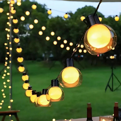 Solar string lights featuring warm white twinkle bulbs, perfect for outdoor decorative lighting in 16.4ft and 32.8ft lengths. 0
