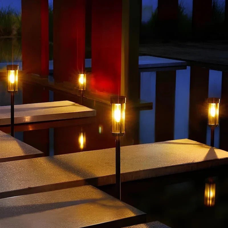 Solar torch lights outdoor with flickering flame effect, designed for garden and yard pathways, featuring a sleek black finish for stylish outdoor lighting. 1